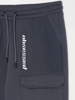 Cropp Spodnie*Dresowe joggery z efektem reflective szary